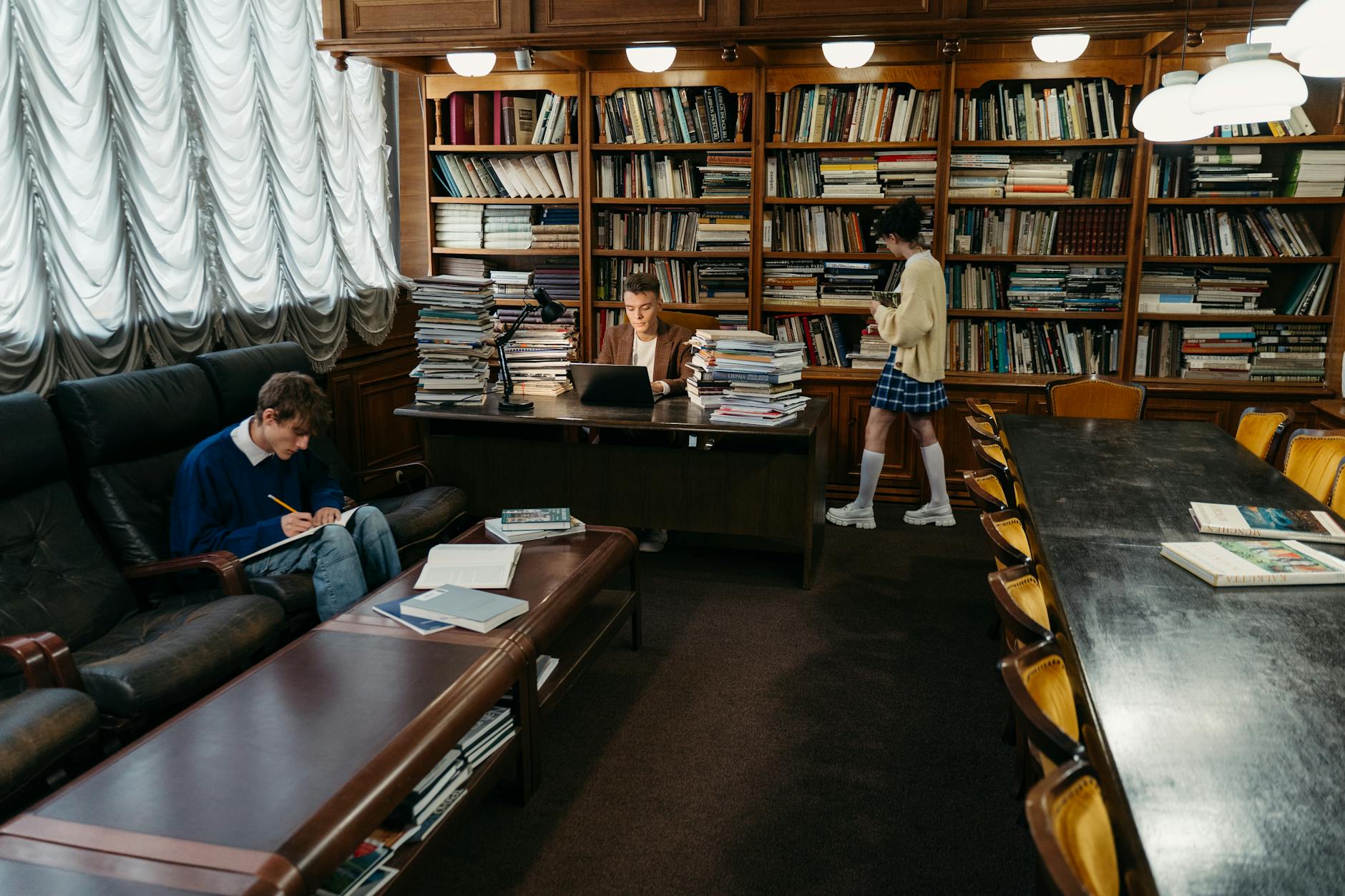 Students engaging in study and research within a classic library setting — TransferCredit.org
