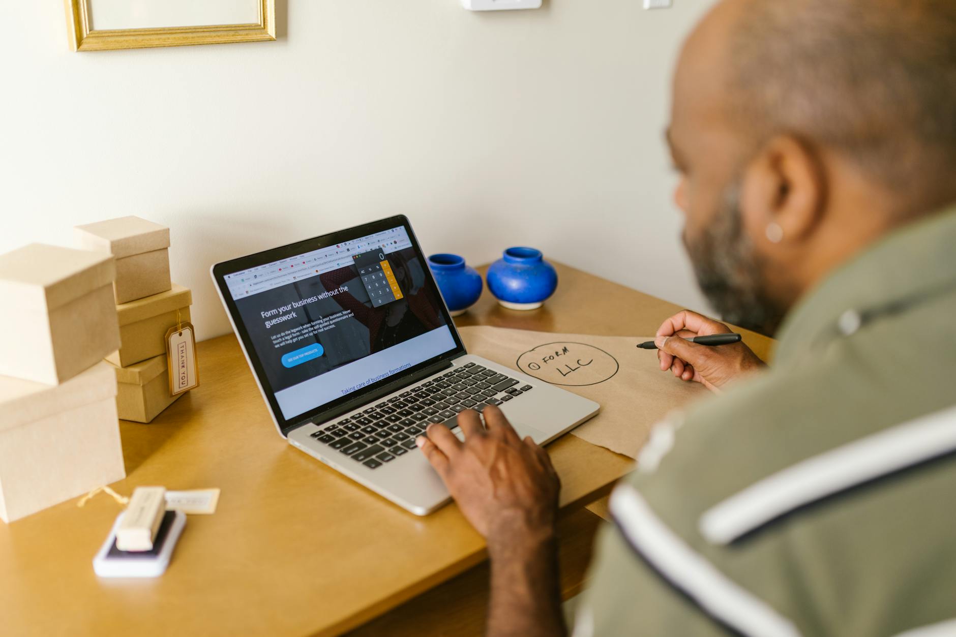 Entrepreneur at a desk using a laptop for business planning. Ideal for tech and startup themes — TransferCredit.org