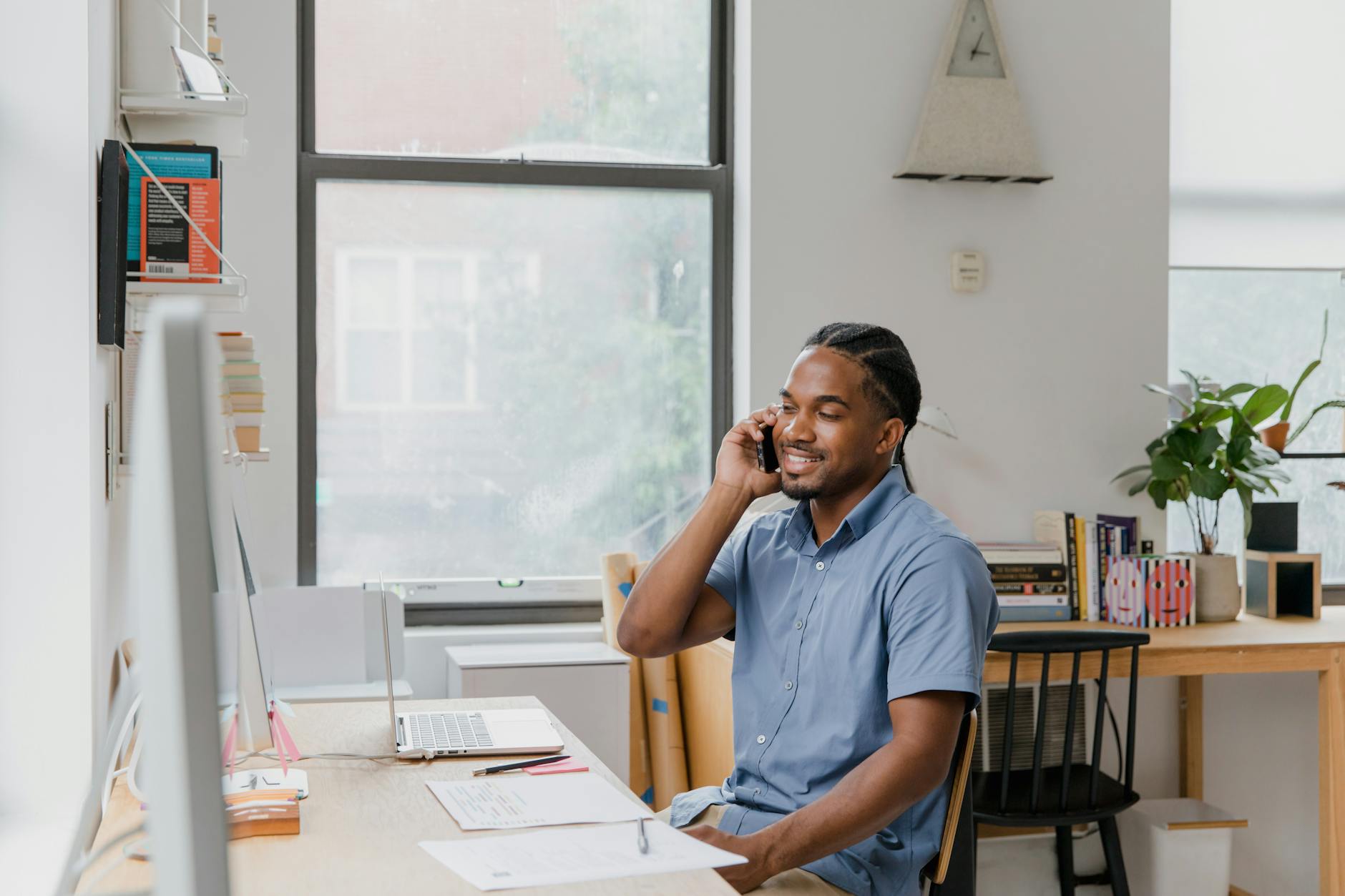 Adult man engaged in office work, speaking on phone, showcasing a professional environment — TransferCredit.org