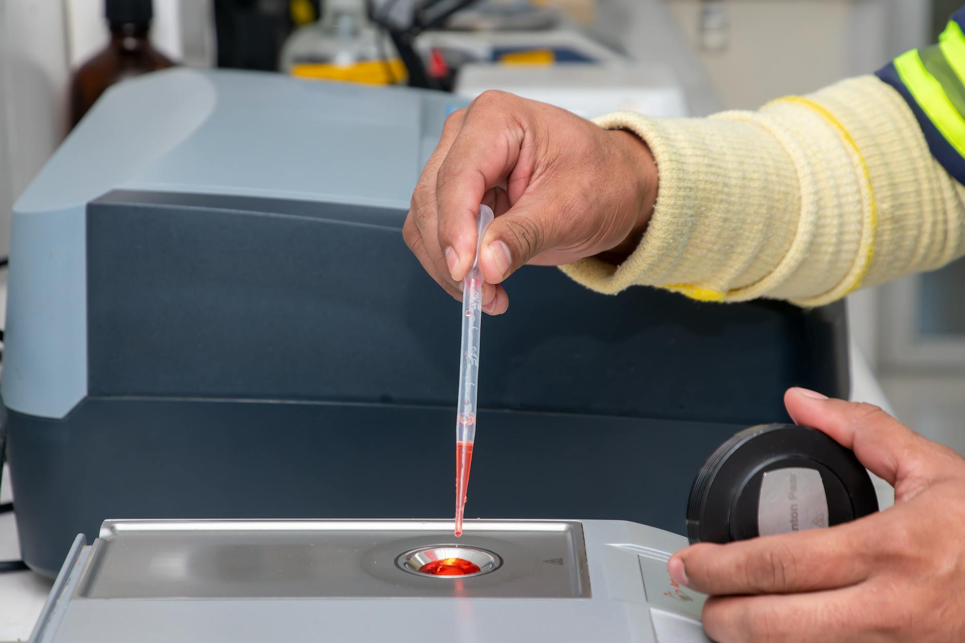 Close-up of a laboratory technician using a pipette for precise measurement in a modern lab — TransferCredit.org