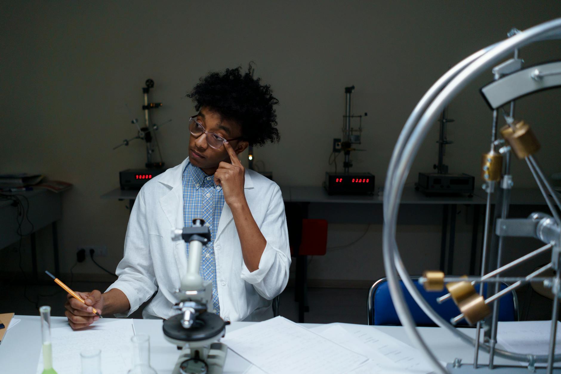 A young adult conducting scientific research in a modern laboratory setting — TransferCredit.org