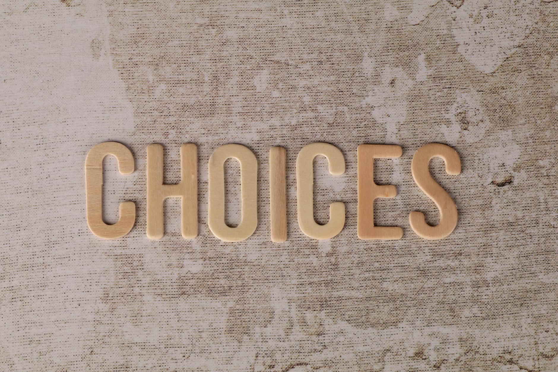 Wooden letters spelling 'choices' on a textured surface, symbolizing decision-making — TransferCredit.org