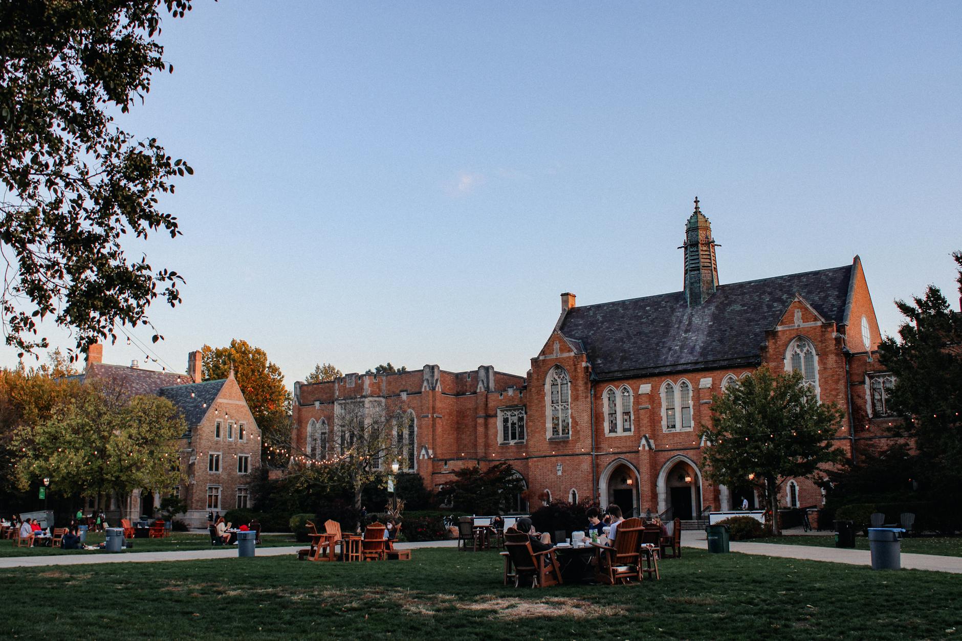 Scenic view of Notre Dame campus with Gothic-style buildings and students on a green field — TransferCredit.org