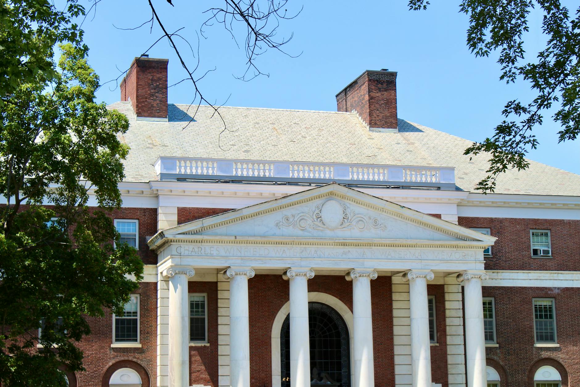 A classic brick university campus building with columns in Burlington, Vermont — TransferCredit.org