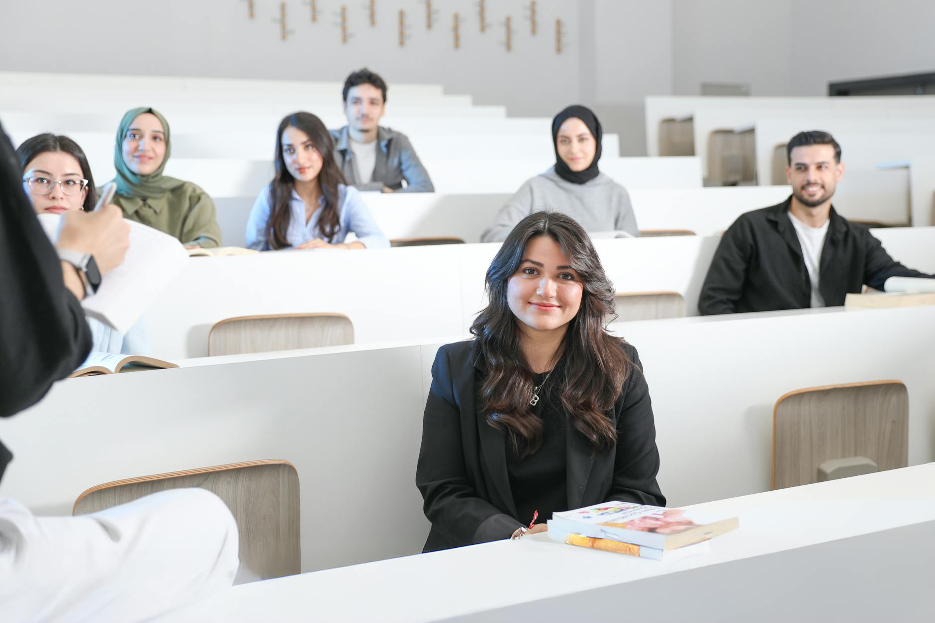 Students listening attentively in a bright university lecture hall — TransferCredit.org
