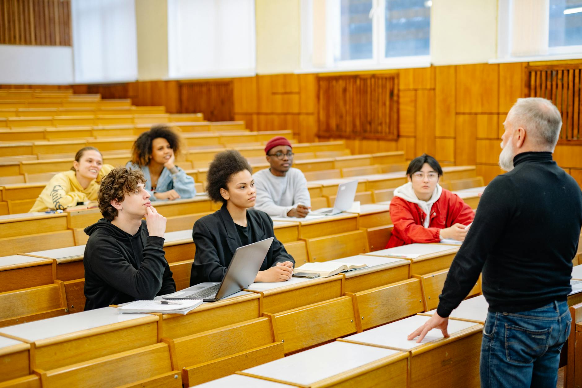 University students engaging in a diverse classroom setting with a lecturer — TransferCredit.org