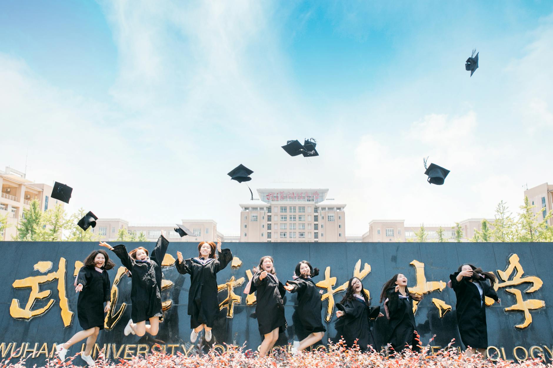 Graduates celebrate their success by tossing caps at Wuhan University, China — TransferCredit.org