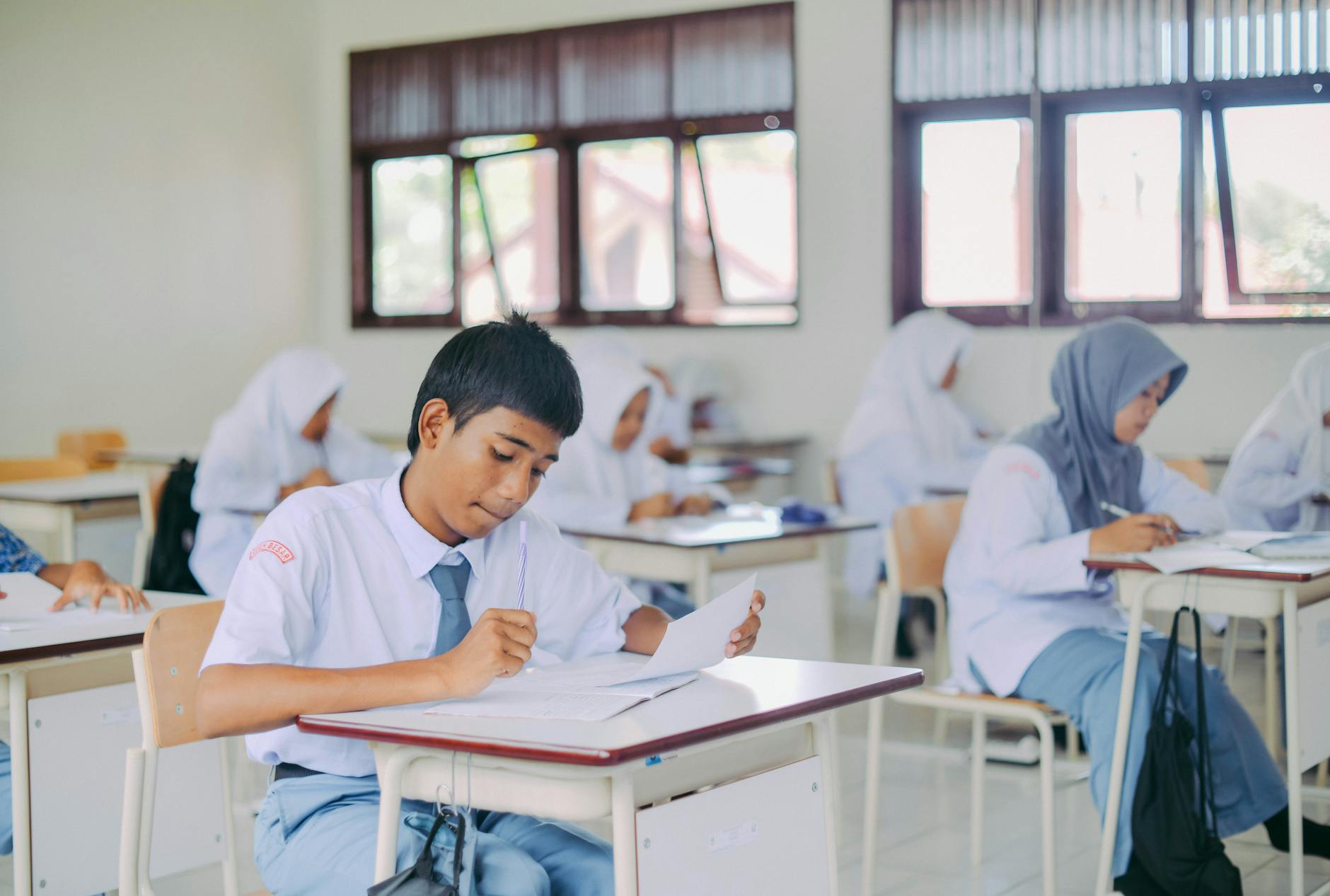 High school students in Indonesia studying in a classroom setting — TransferCredit.org