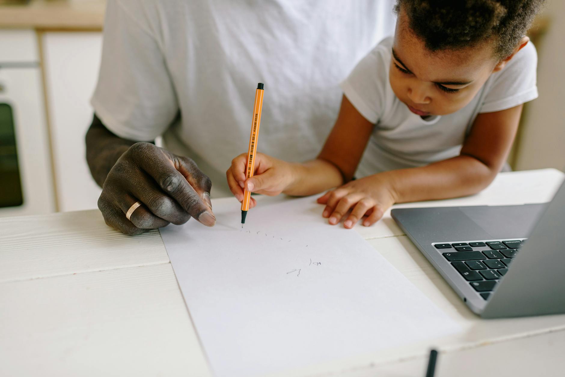 Father and son engage in a creative drawing session at home, fostering learning and connection — TransferCredit.org
