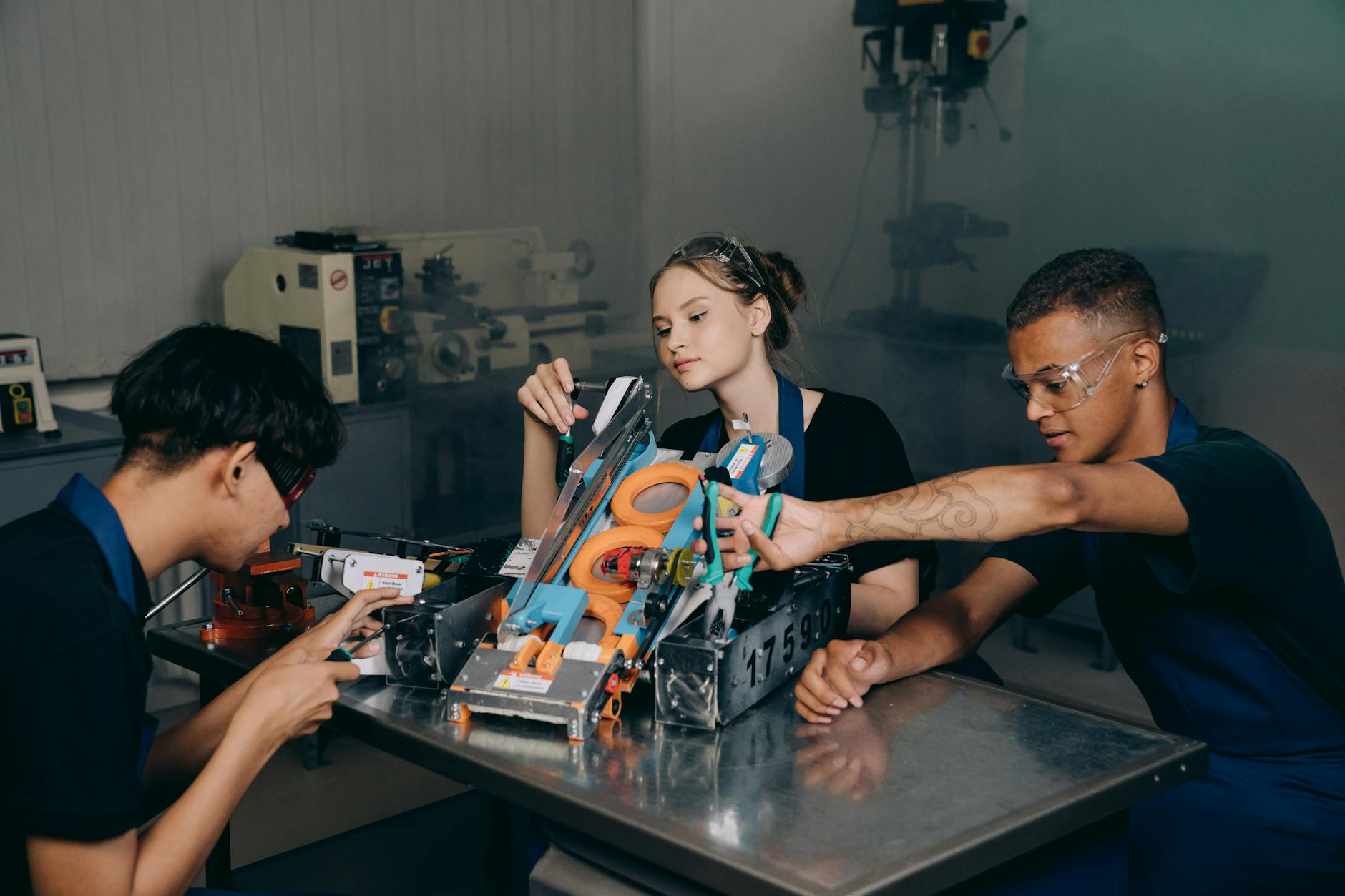 Students engaged in assembling a robotics project in an educational lab setting — TransferCredit.org