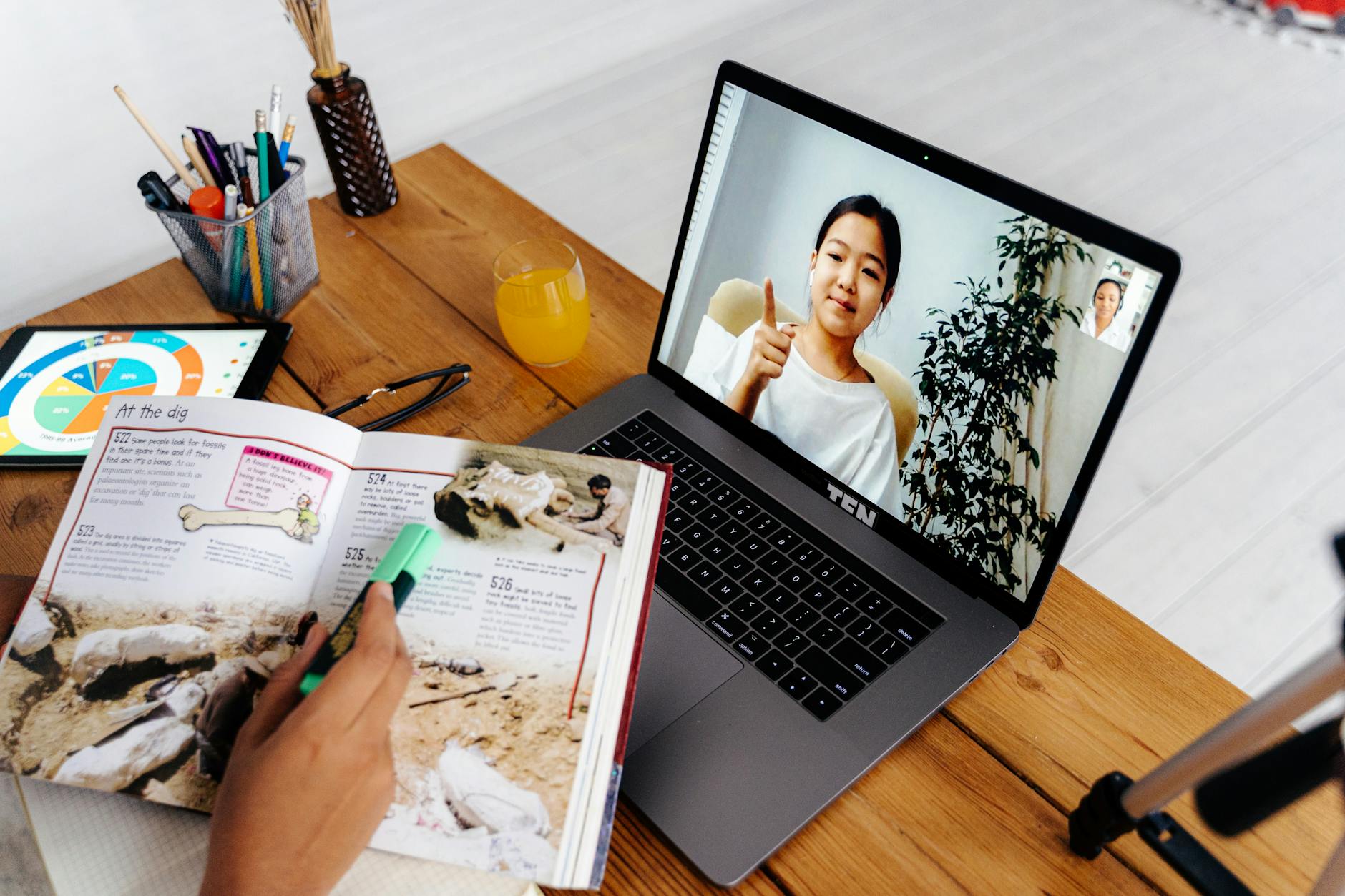 Online teaching session with digital tools, featuring a woman on a laptop screen and educational materials — TransferCredit.org