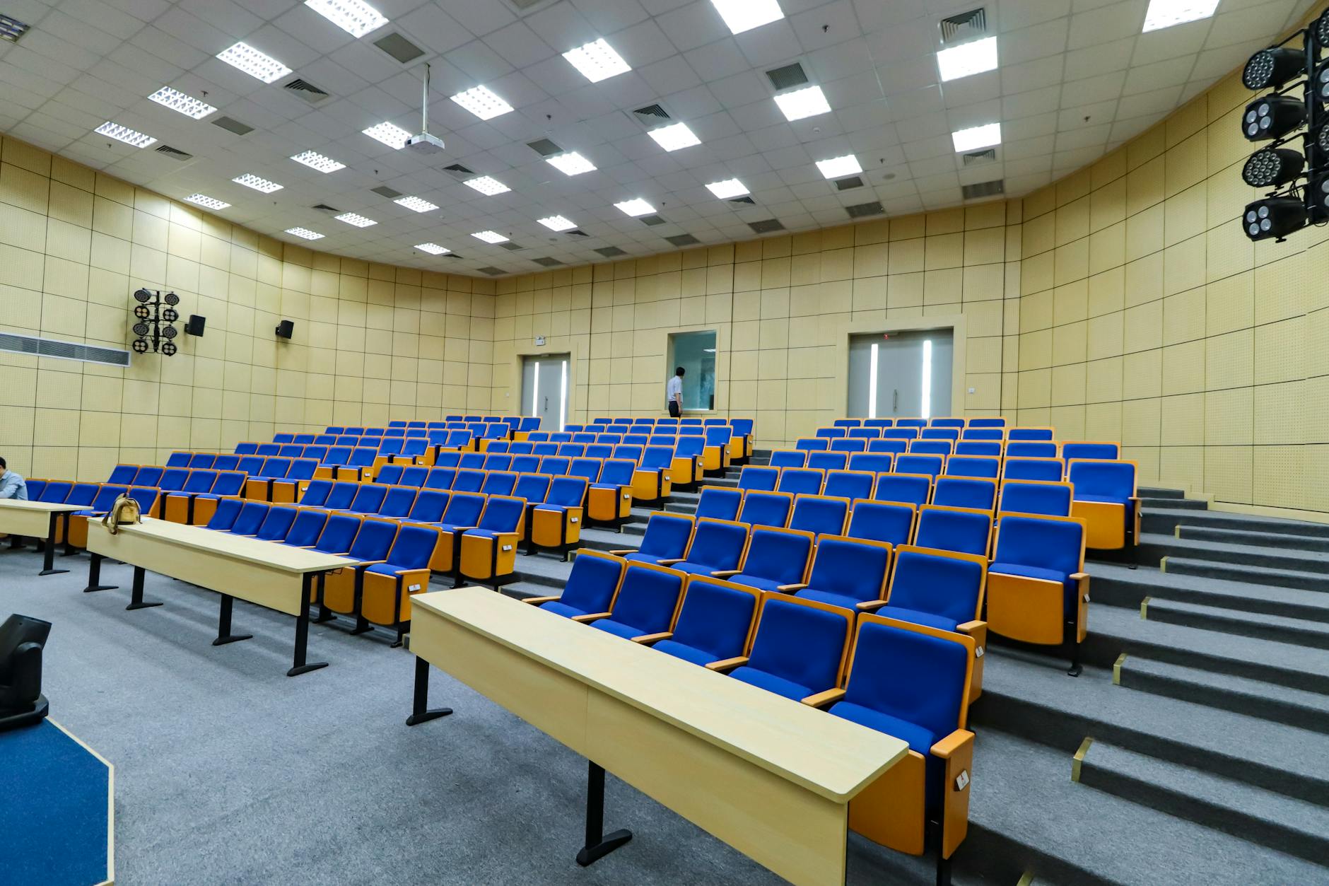 Spacious lecture hall with blue seats and desks ready for students — TransferCredit.org