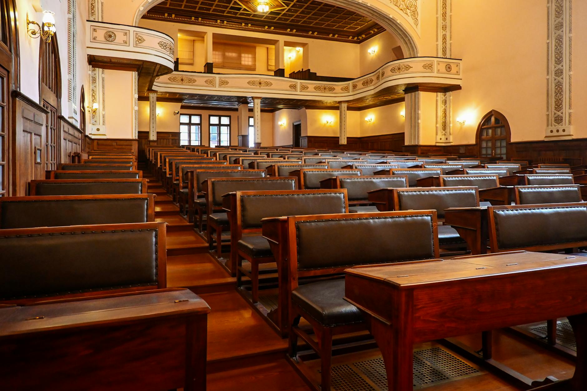A historic lecture hall featuring wooden benches and classic architectural details, ideal for educational settings — TransferCredit.org